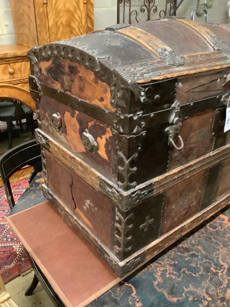 A late Victorian leather and metal mounted dome top trunk with scrap-work interior, length 76cm, depth 48cm, height 62cm